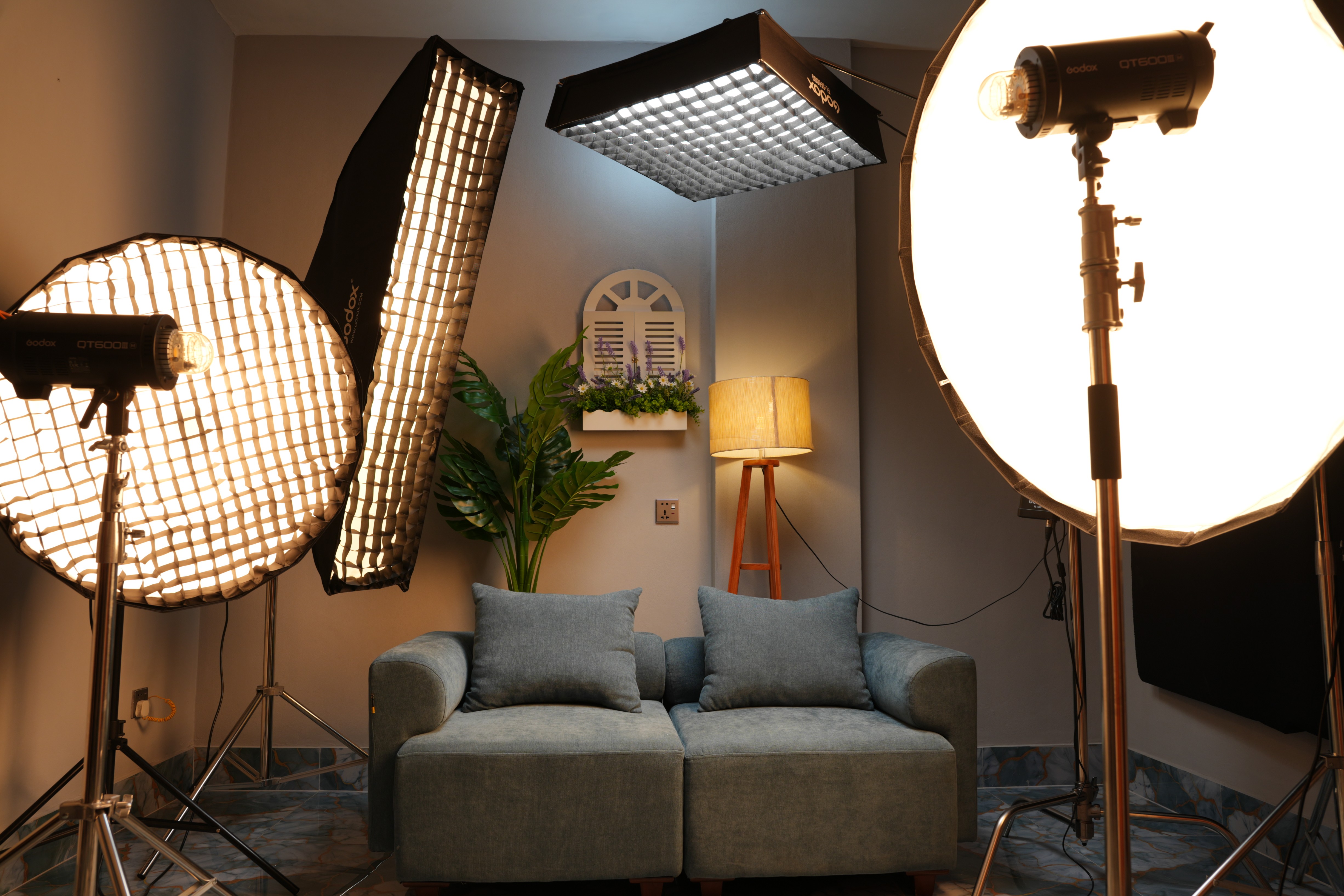 PlatiRoll studio with professional softbox lighting aimed at a cozy sofa set